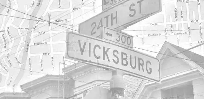 Black-and-white sign for 24th St and Vicksburg with a map in the background.